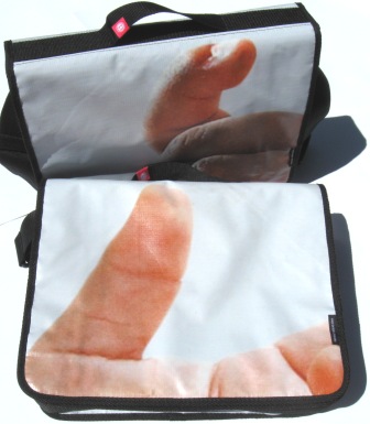 A recycled laptop bag made from Powershop's Baby Trump billboard campaign.